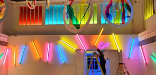 woman installing light tubes with colourful gels