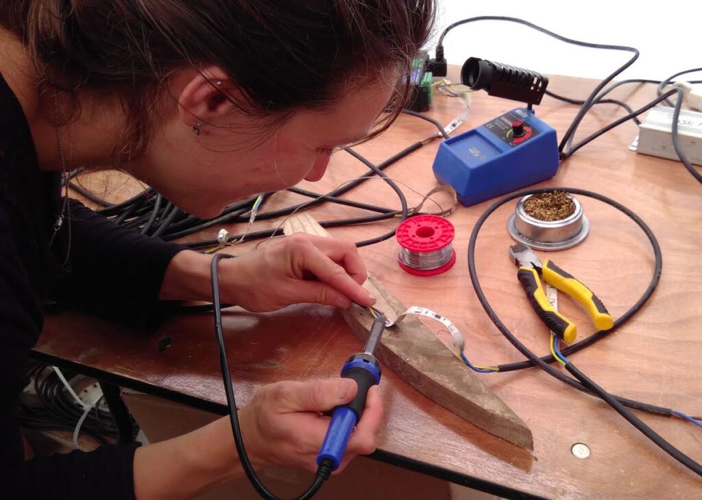 woman soldering LED tape