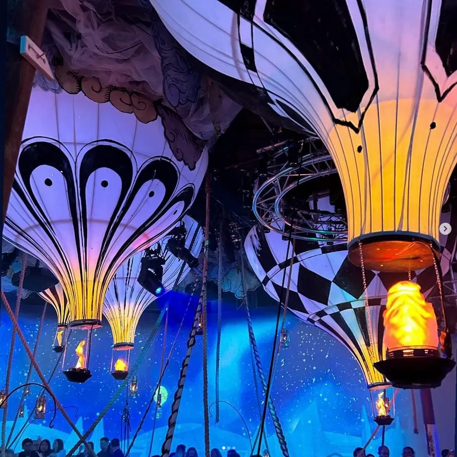 A hot air balloon with an illuminated replica hot air burner beneath, designed as a theatrical piece for The Grand Exhibition immersive theatre project.